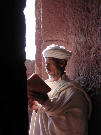 Lalibela, in the northern highlands of Ethiopia, is 
famous for its rock-hewn churches. A priest is seen reading a manuscript
 written in the ancient language of Ge’ez. Image courtesy of the Houston
 Museum of Natural Science